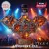 Glass whiskey bottle shaped like a bat with Ozzy text, featuring a bat figurine, concert lighting background.!