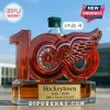 Whiskey bottle with a red cap celebrating Hockeytown's 100th Anniversary.
