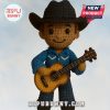 Crochet country singer doll in cowboy hat holding guitar on sky background.