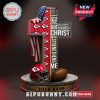 Kansas City Chiefs cross-shaped statue with Bible verse and football elements.