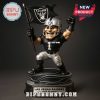 Las Vegas Raiders mascot figure under studio lighting with raised flag and custom jersey.