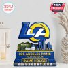 LA Rams standee on white shelf with decorative background.