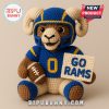 Crocheted ram plushie in a football uniform.
