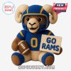 Crocheted ram plushie in a football uniform.