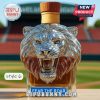 Lion head liquor bottle with light wooden cap.