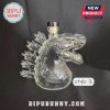 Empty clear glass liquor bottle shaped like Godzilla, marked