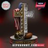 New Orleans Saints cross-shaped statue with Bible verse and football elements.