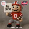 Crochet football player doll in red and grey with Go Bucks sign and football.