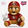 San Francisco 49ers crochet doll with red uniform and helmet holding football.