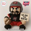 A crochet Tampa Bay Buccaneers football player doll holding a sign saying 