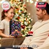 A child and parent smiling while holding the Def Leppard Advent Calendar 2025.