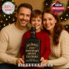 A family holding the Jack Daniel's 150th Anniversary Advent Calendar near a Christmas tree.