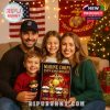 Family posing with the Marine Corps 250th Anniversary Advent Calendar 2025, surrounded by Christmas decorations.