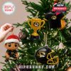 Missouri Tigers ornaments hanging on a Christmas tree, including a trophy, Santa figurine, and helmet.