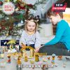 Children playing with a Nativity Advent Calendar set by the Christmas tree.