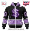 A close-up of the front of the Seattle Kraken hoodie, showcasing the team logo and purple bandana pattern details.