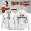 White zip up hoodie with red heart on front and Shawn Mendes On The Road Again 2025 tour dates on back.