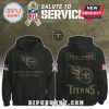 Front and back views of a Tennessee Titans Salute to Service hoodie in black with tan military print and NFL patches.