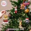 Winnie the Pooh ornaments being hung on Christmas tree.