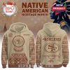 Beige 49ers hoodie with Native-inspired motifs, front dreamcatcher logo, back tomahawk design, and full team branding!