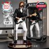 Standing Bob Dylan figurine mid-performance with electric guitar and microphone on platform beside styled box and monitor render!