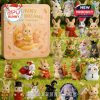 A pastel-colored advent calendar with bunny characters on the cover and numerous tiny bunny figurines dressed for Christmas and winter, set in a lush green field!