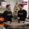 Two men wearing Oasis sweaters exchanging Oasis Advent Calendar by a Christmas tree!