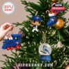 Toronto Blue Jays mini collectibles like a toy train, snow globe, and player figure hang on a lit Christmas tree, bringing sporty cheer to holiday décor!