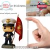 Toy soldier figure celebrating the U.S. Marine Corps 250th anniversary shown next to a hand measuring the quality and thickness of the collectible's transparent base!