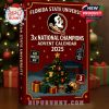 The FSU advent calendar box is displayed on a holiday table near ornaments and a lit tree. The artwork features a stadium scene, Christmas decorations, and bold references to the university’s football victories!