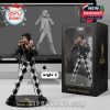 Freddie Mercury figurine in black leather jacket and checkered pants, striking a stage pose, displayed in premium packaging.