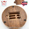 Battery housing compartment of the LED base revealed from the bottom. Features a realistic wood texture and rubber pads for stable placement on surfaces.