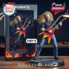 Megadeth guitarist figurine with a double-neck guitar, displayed on a fiery base, in collector's edition packaging.