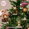 A hand places Jamie’s figure onto the tree, surrounded by other Outlander figures and winter-themed charms, creating a magical holiday arrangement!