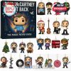An advent calendar featuring collectible Paul McCartney figurines, each representing memorable moments from his career. The design is festive with rainbow colors and musical elements.