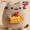 Pusheen holding a slice of apple pie with a red apple on top, representing a Christmas or autumn scene.
