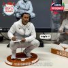 Steve Sarkisian Texas Longhorns figure in white tracksuit, crouched with clipboard on a branded orange base beside themed packaging!
