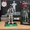 Realistic figurine of NBA YoungBoy with hooded jacket and expressive hands, captured next to a black-edged box featuring YoungBoy Rich branding!