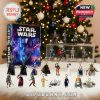Close-up of Star Wars 2025 Advent Calendar figures arranged in front of a Christmas tree with holiday lighting!