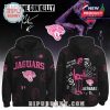 A black hoodie with the Jacksonville Jaguars logo, custom artwork by Machine Gun Kelly, and vibrant pink graphics.