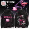 A black hoodie with Cincinnati Bengals’ logo, featuring Machine Gun Kelly’s vibrant pink design elements.