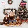 A holiday living room scene showing a cheerful family posing with their food-themed advent calendars and ornaments hanging across a decorated Christmas tree, blending tradition with playful modern style!