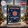 The advent calendar is displayed in a winter evening setup, decorated with candy canes, holly, ornaments, and the Auburn logo shining front and center!