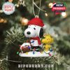 Snoopy and Woodstock ornaments wearing Georgia Bulldogs colors hanging among tree branches!