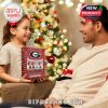 A child happily presenting the Georgia Bulldogs Advent Calendar box as a holiday gift in a cozy Christmas setting!