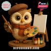 An artistic owl figure poses with a brush and palette near an easel, adding creativity and color to the ornament collection!