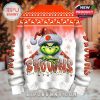 Back of a holiday sweater featuring the Grinch wearing a Santa hat with a Browns logo and bold Browns lettering with Christmas lights!