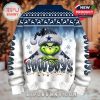 Back of a holiday sweater featuring the Grinch grinning in a Dallas Cowboys-themed hat with bold team lettering and winter design!