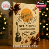 A close-up shot of the Neil Young Advent Calendar 2025 featuring a golden box with brown bows and illustrations of musical instruments and holiday icons.