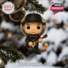 A Neil Young guitar-playing figurine ornament hanging on a Christmas tree with snow and lights in the background.